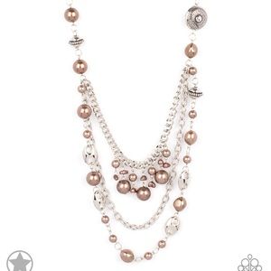 A silky brown ribbon replaces a traditional chain to give an elegant look.